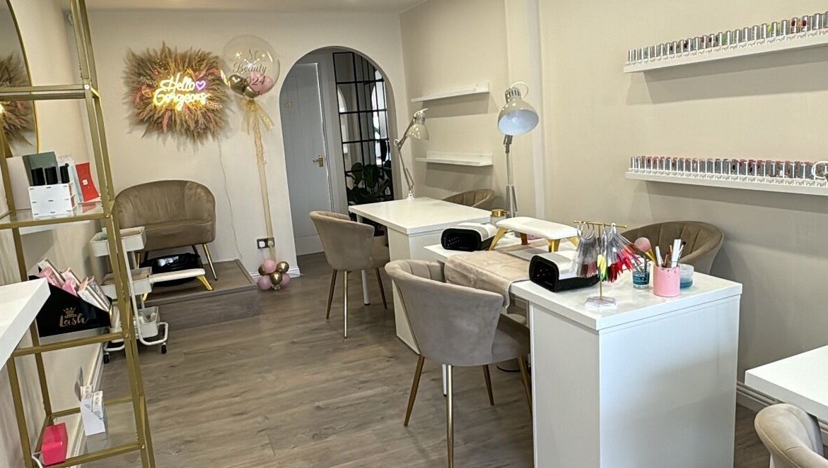 Elegant interior of RMC Beauty in West Calder, Scotland, GB, featuring stylish seating and nail stations.