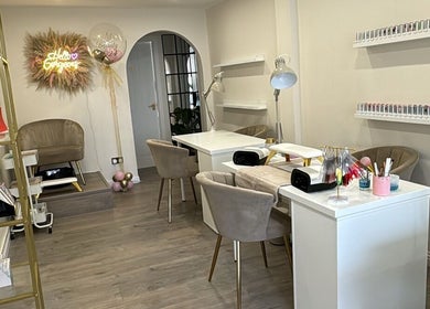 Elegant interior of RMC Beauty in West Calder, Scotland, GB, featuring stylish seating and nail stations.