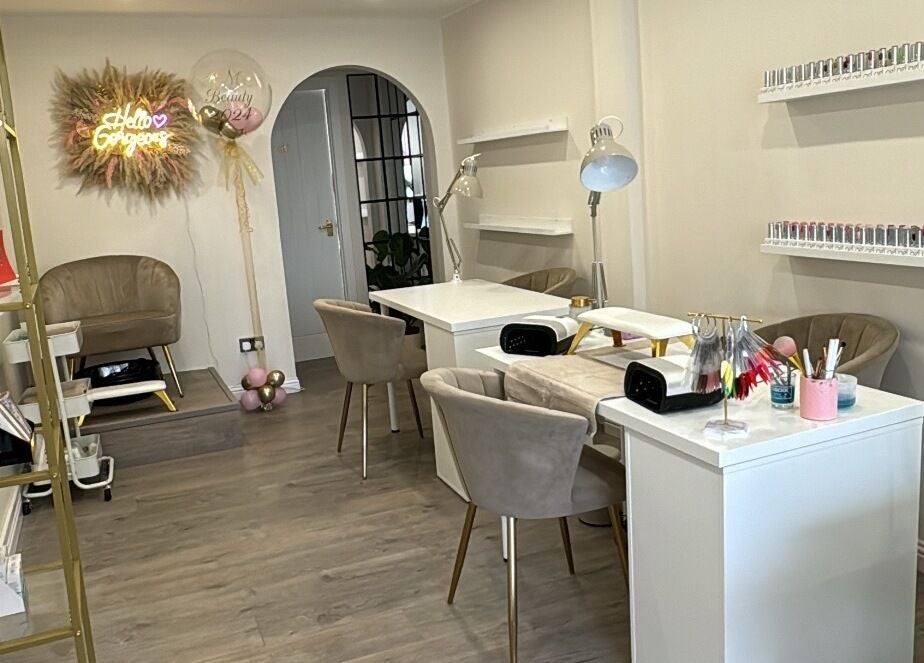 Elegant interior of RMC Beauty in West Calder, Scotland, GB, featuring stylish seating and nail stations.