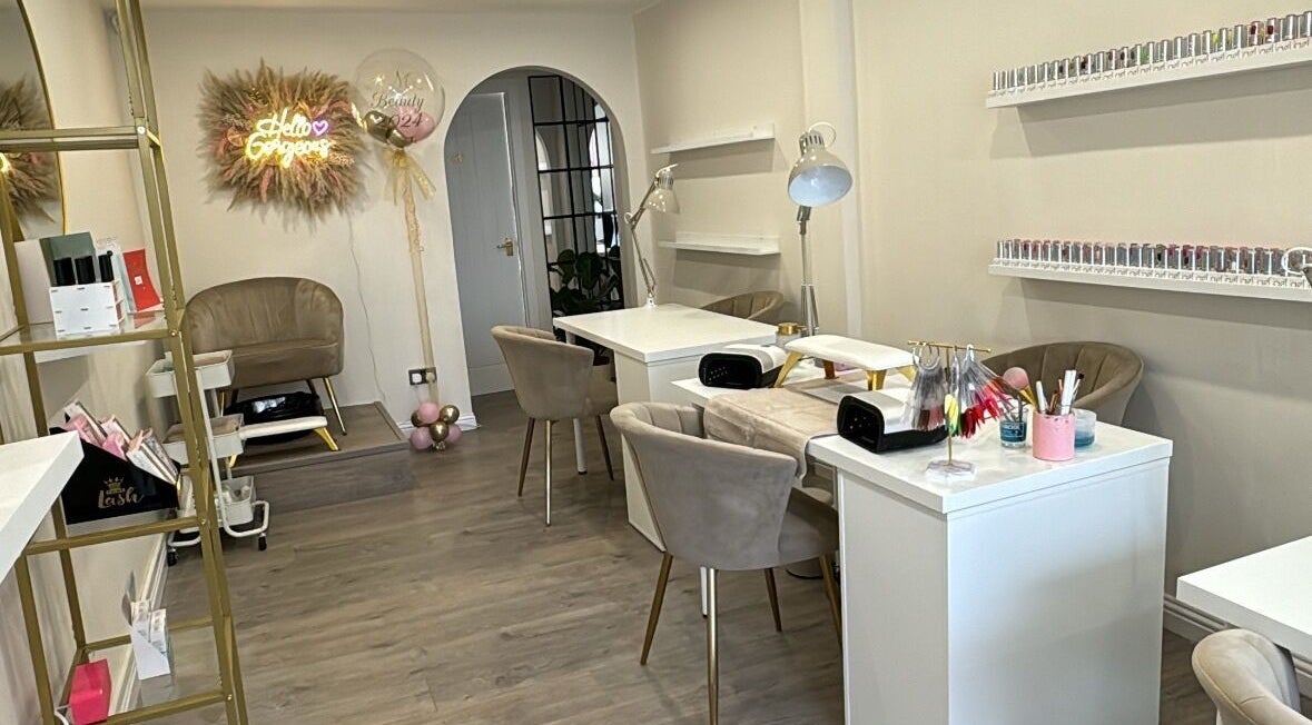Elegant interior of RMC Beauty in West Calder, Scotland, GB, featuring stylish seating and nail stations.