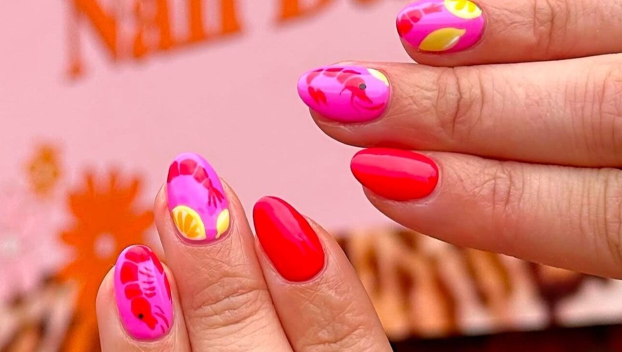 Vibrant nail art at Gorgia Nails, Yate, England, GB, featuring pink and red designs with floral accents.