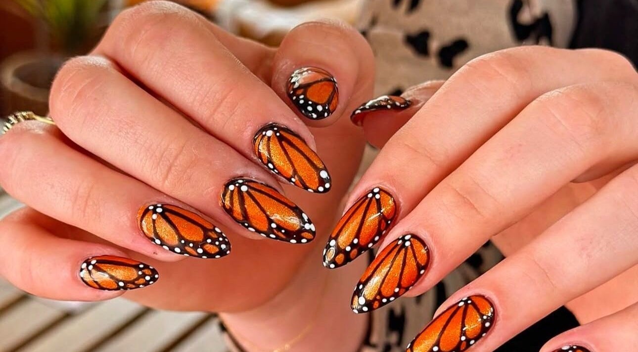 Intricate butterfly nail art at Gorgia Nails, Yate, England, GB offering vibrant, creative designs.