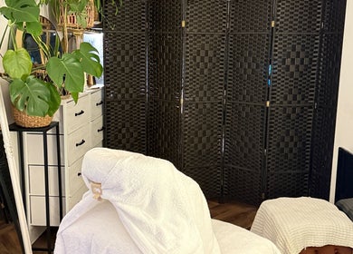 Tranquil massage room at Bloom & Ouud, Birmingham, England, GB with plants and wicker decor.
