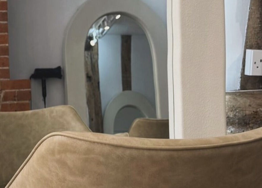 Modern salon interior with mirrors and cozy seating at Leigh-Anne Hairdressing, Woodbridge, England, GB.