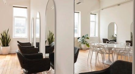 Modern interior of Tudoi Hair Studio in Melbourne, Victoria, AU with stylish chairs and mirrors.