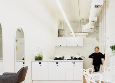 Bright, minimalist interior of Tudoi Hair Studio in Melbourne, Victoria, AU with modern seating and decor.