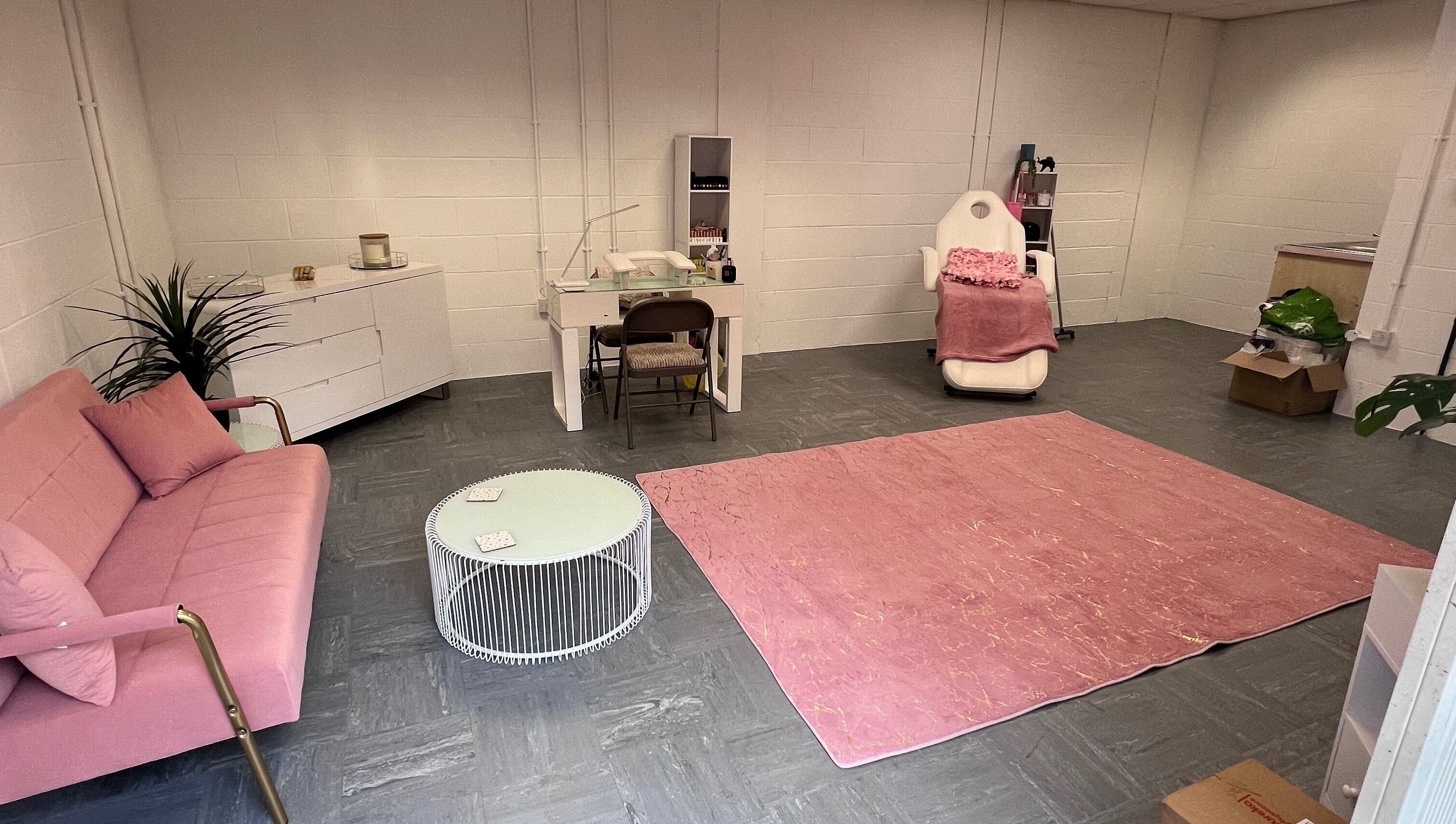 Chic beauty salon room at The Beauty Office, Nuneaton, England, GB, featuring pink sofa and treatment chair.