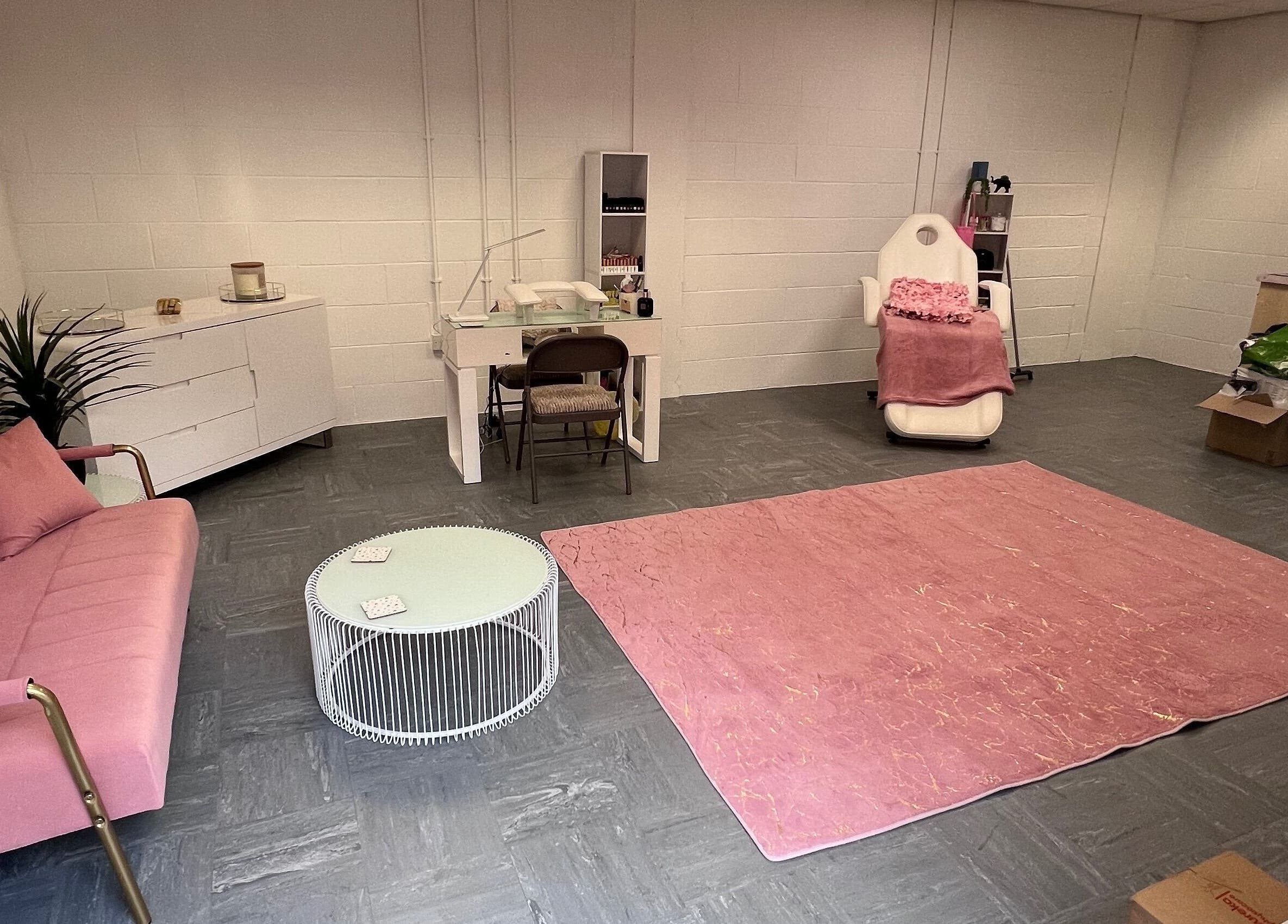 Chic beauty salon room at The Beauty Office, Nuneaton, England, GB, featuring pink sofa and treatment chair.
