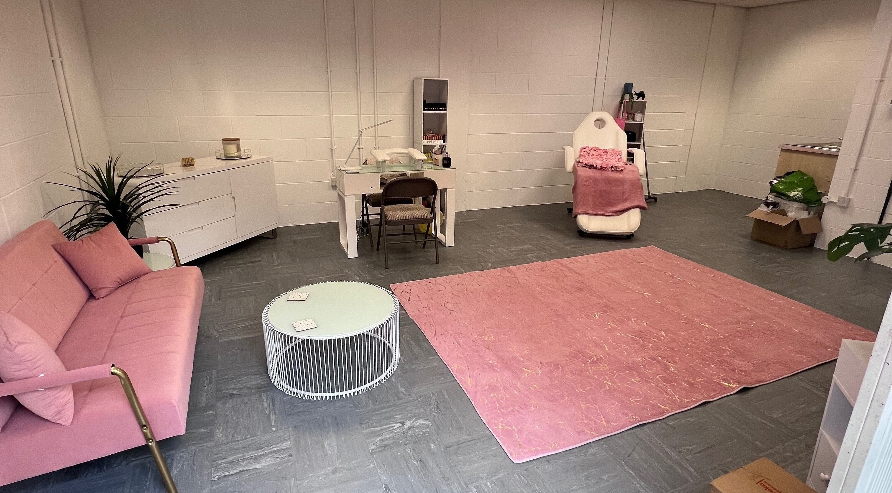 Chic beauty salon room at The Beauty Office, Nuneaton, England, GB, featuring pink sofa and treatment chair.