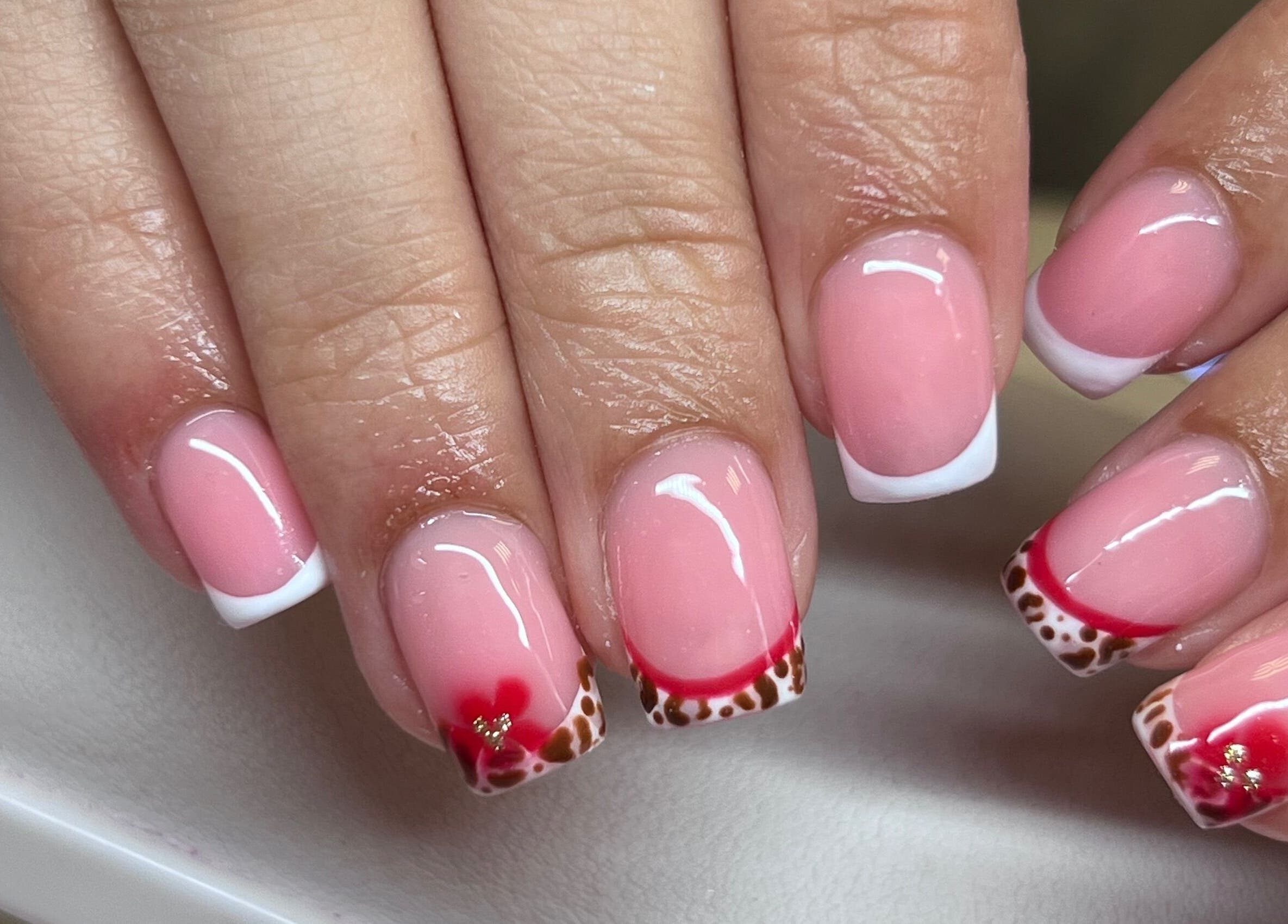 Elegant nail art with pink and red designs at The Beauty Office, Nuneaton, England, GB.