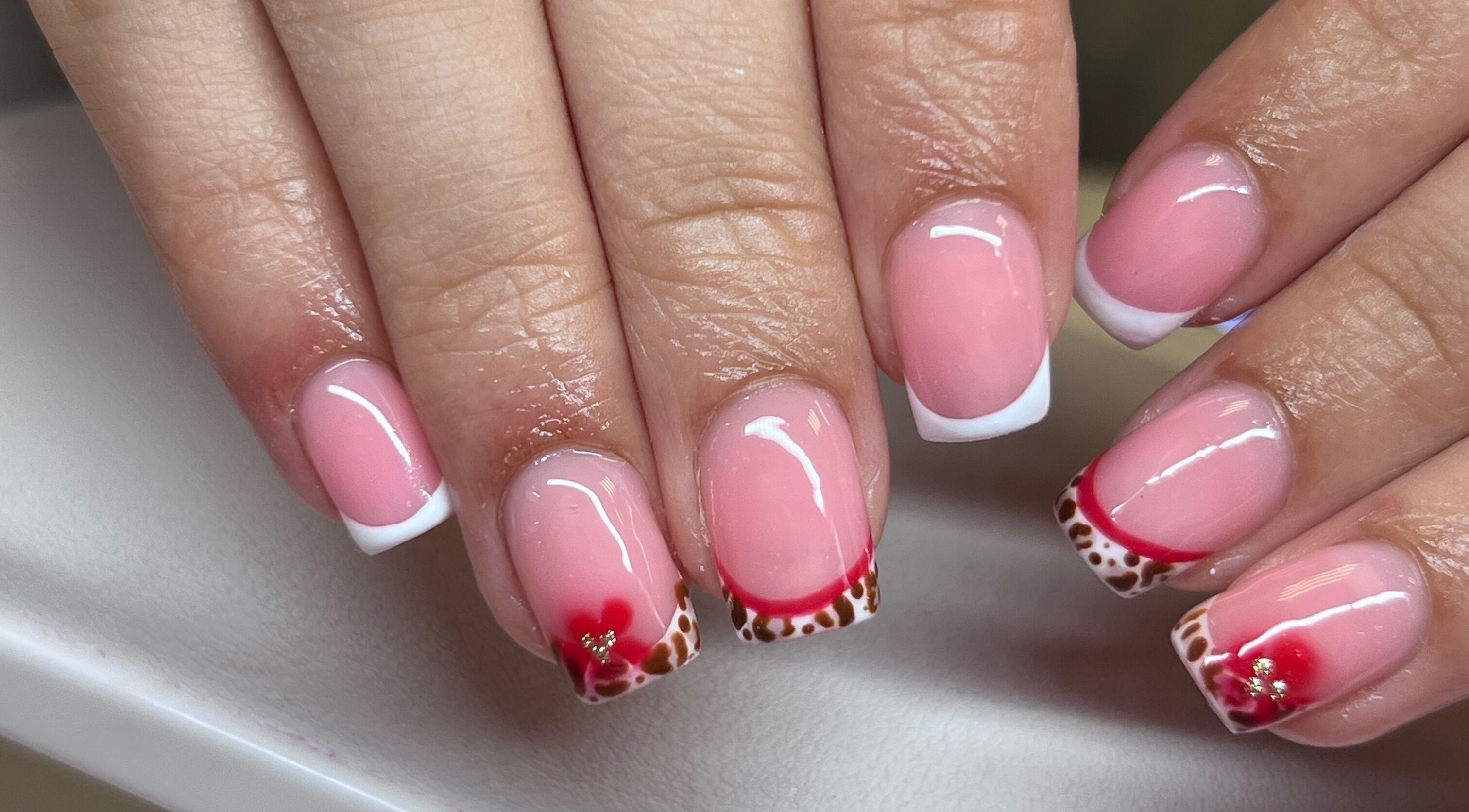Elegant nail art with pink and red designs at The Beauty Office, Nuneaton, England, GB.