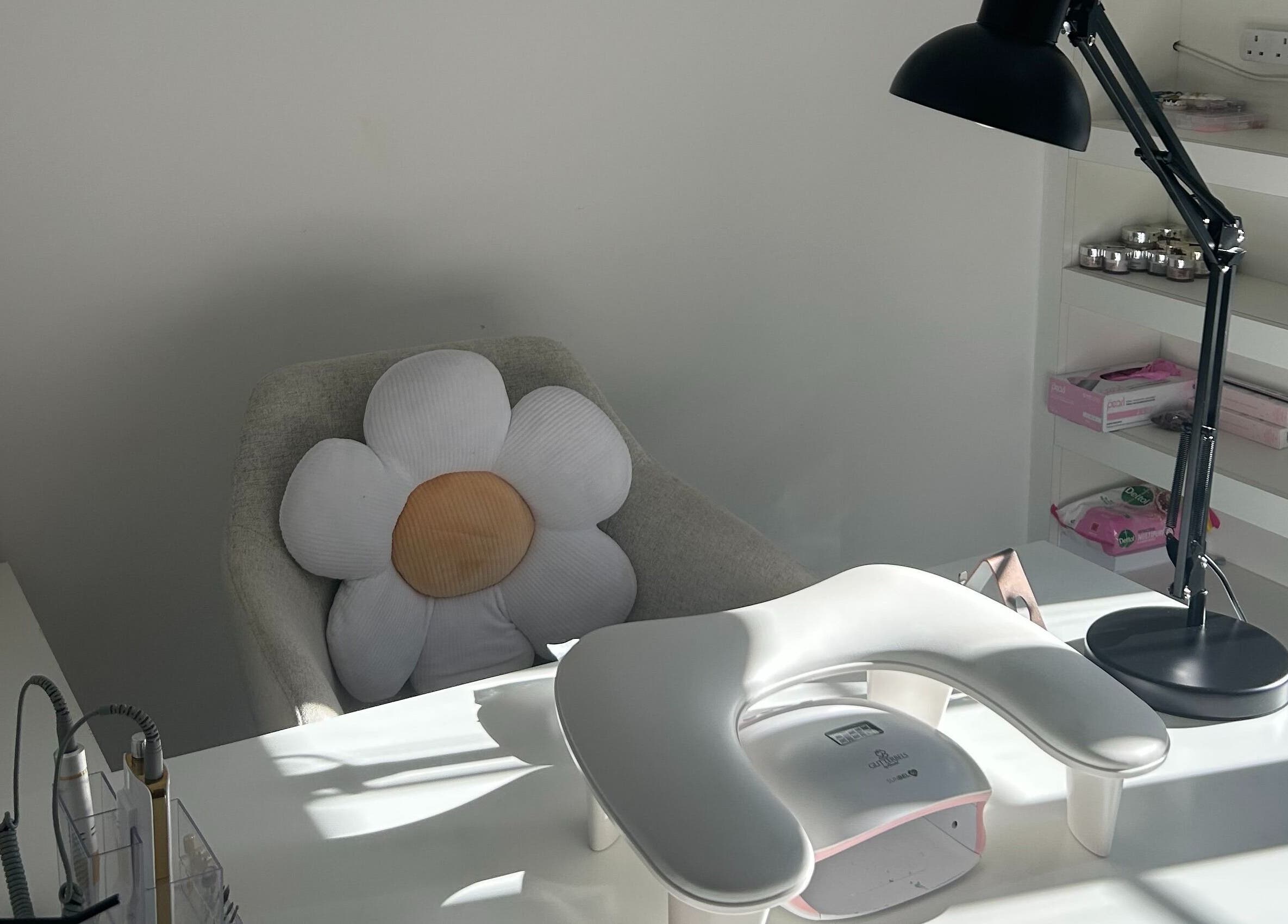 Cozy nail station at Nails by Daisy, Doncaster, England, GB with a floral cushion and manicure setup.