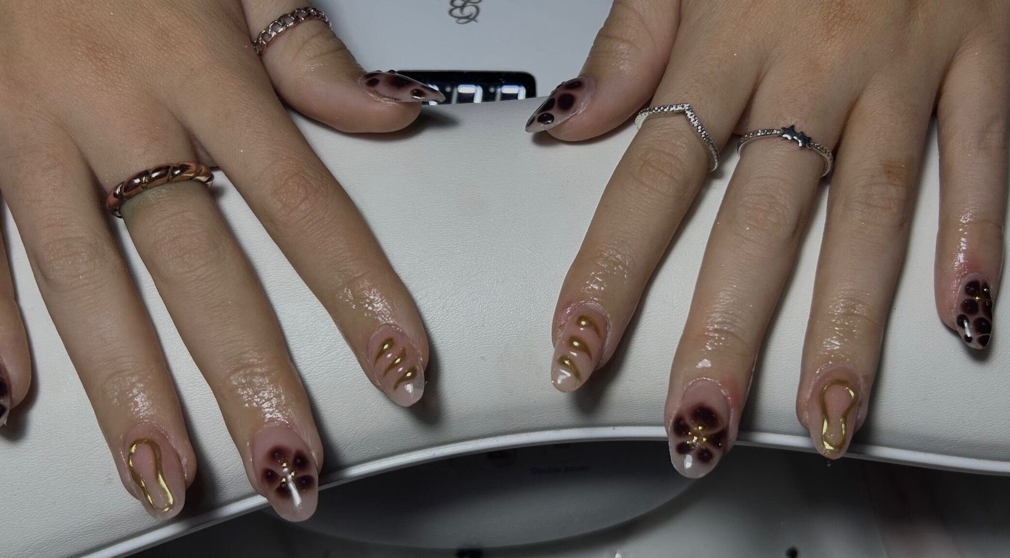 Elegant nail art with gold accents by Nails by Daisy in Doncaster, England, GB.