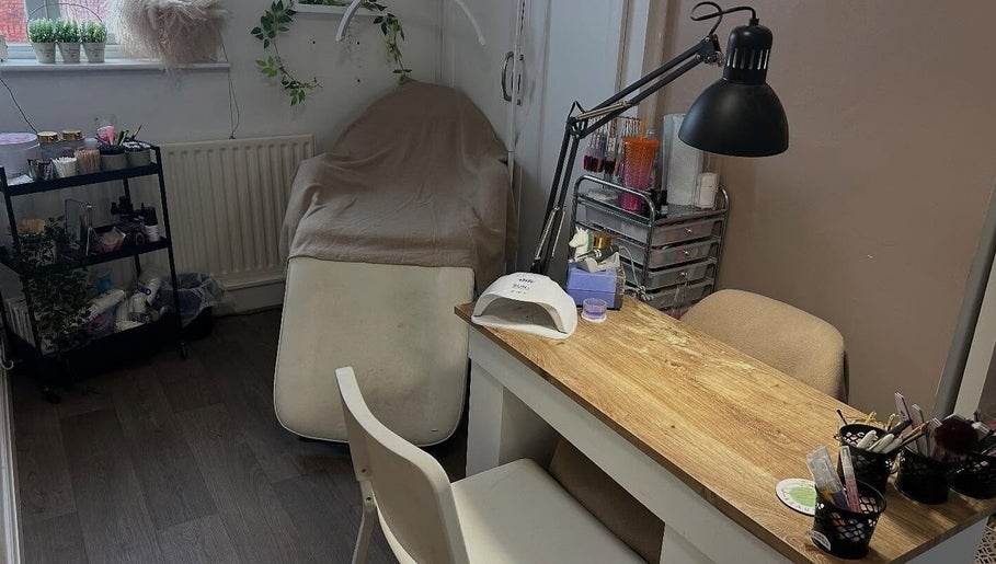 Cozy beauty space at JW Beauty, Tyldesley, England, GB with a treatment bed and a nail desk.