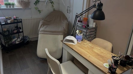 Cozy beauty space at JW Beauty, Tyldesley, England, GB with a treatment bed and a nail desk.