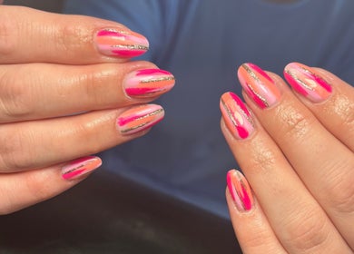Neon striped nails design at JW Beauty in Tyldesley, England, GB showcasing intricate hand detailing.