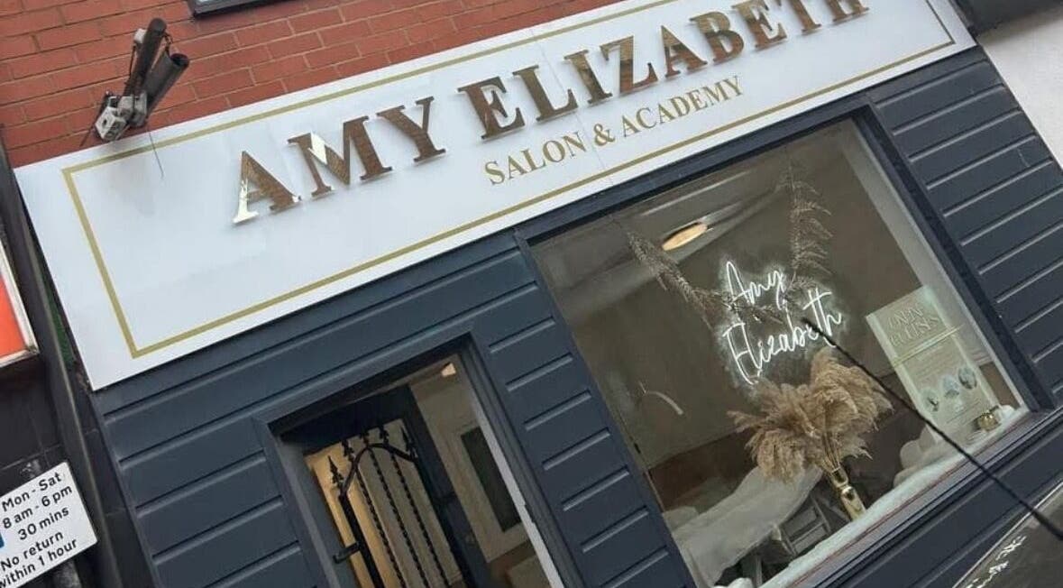 Front view of JW Beauty salon in Tyldesley, England, GB with elegant signage.