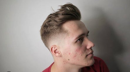 Stylish men's haircut at Tamus in Dublin, County Dublin, IE, showcasing a trendy fade style.