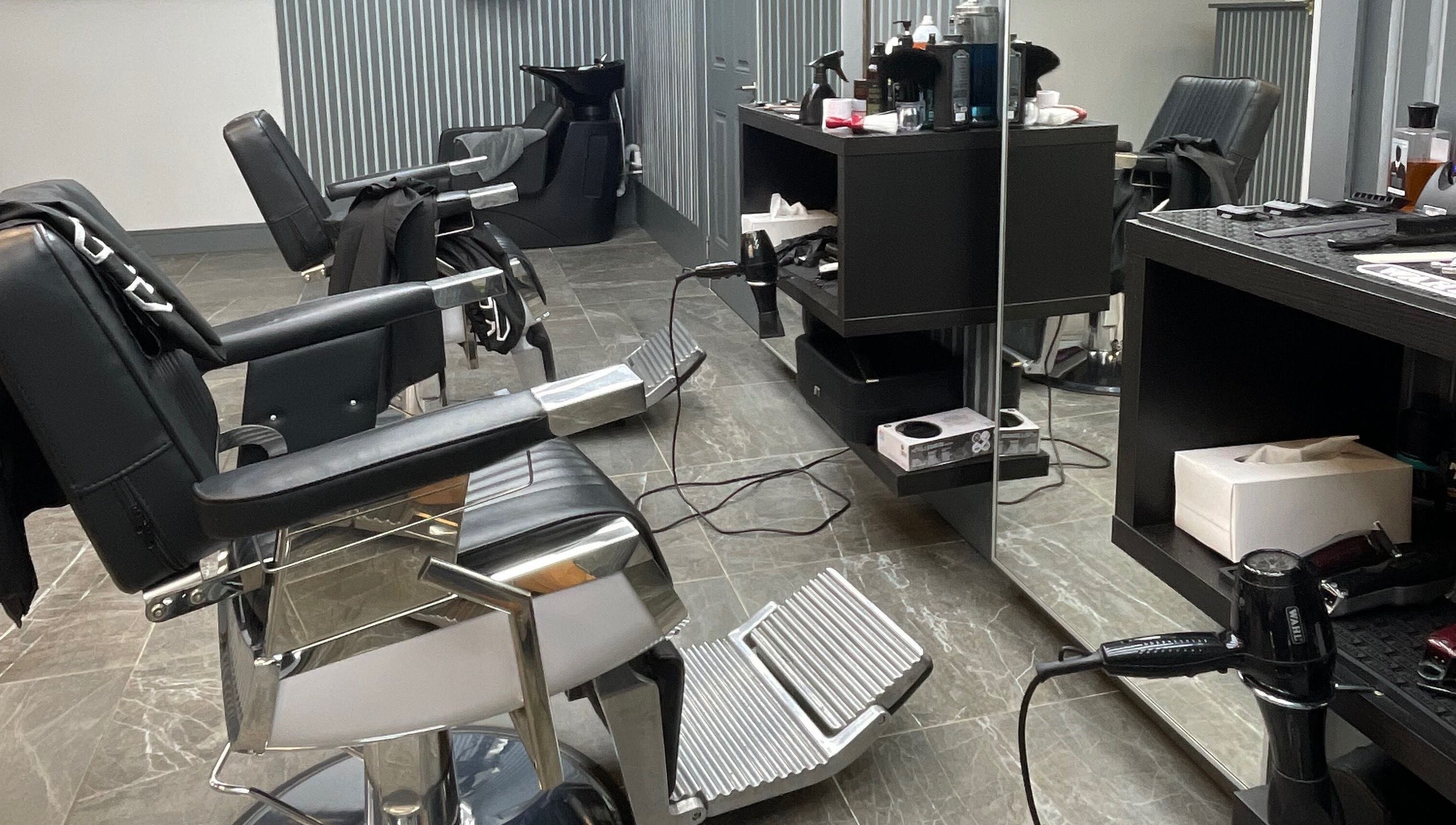 Modern salon interior at Tamus, Dublin, County Dublin, IE with sleek chairs and hair styling tools.