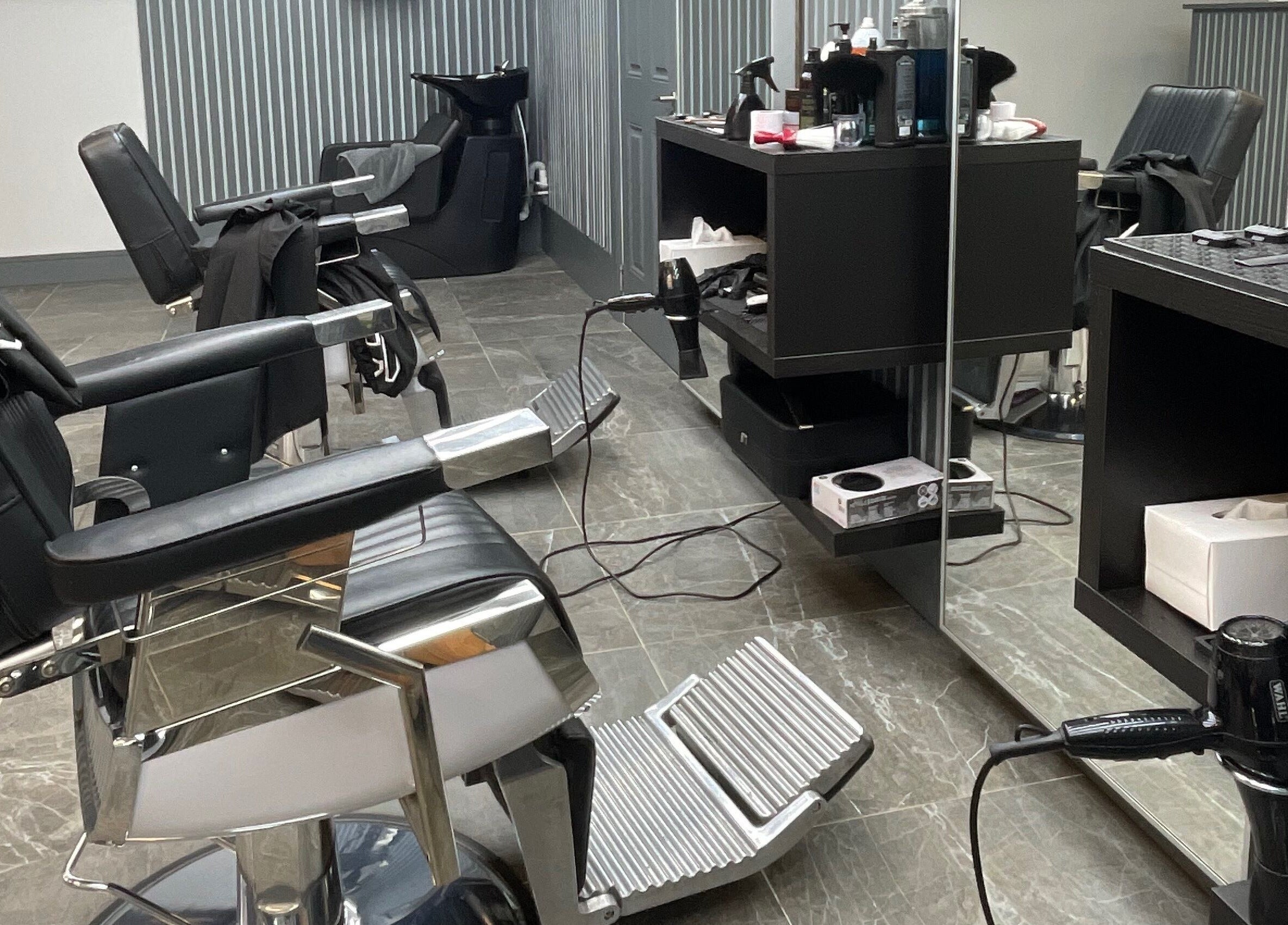 Modern salon interior at Tamus, Dublin, County Dublin, IE with sleek chairs and hair styling tools.