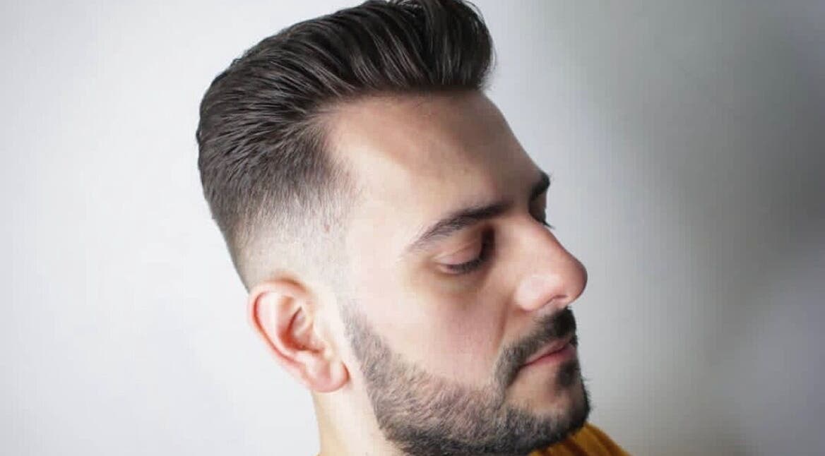 Stylish male haircut at Tamus, Dublin, County Dublin, IE, featuring a clean fade and sharp beard.