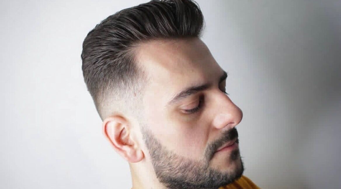 Stylish male haircut at Tamus, Dublin, County Dublin, IE, featuring a clean fade and sharp beard.