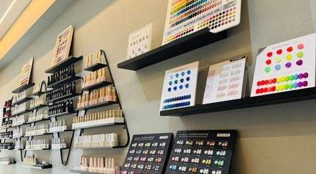 Nail Lounge in Singapore, SG displays a vibrant wall of nail polishes and color samples.