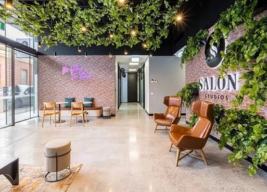 Inviting lounge at KC Hair / Kelvin of Canterbury in Melbourne, Victoria, AU with greenery and stylish seating.