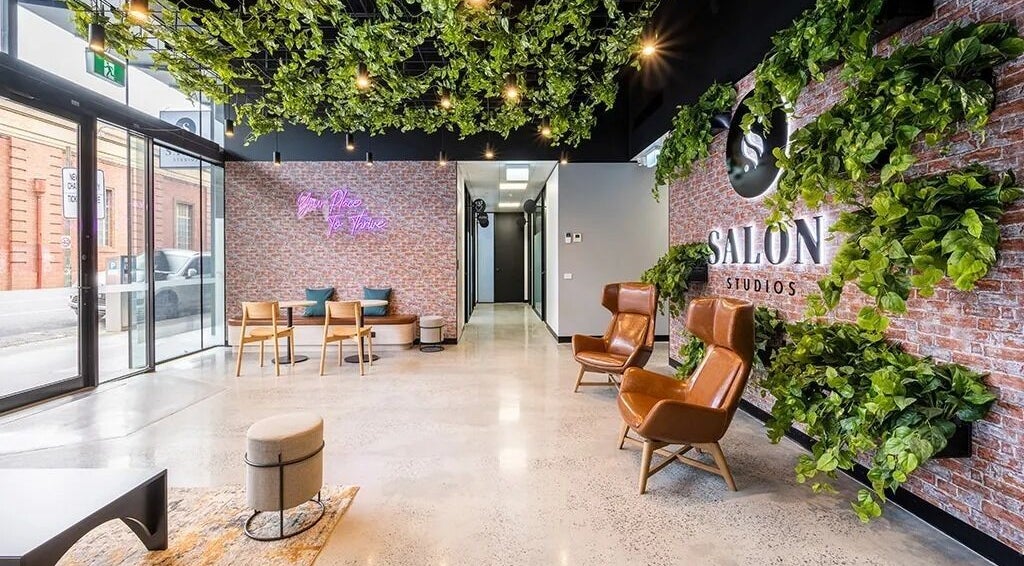 Inviting lounge at KC Hair / Kelvin of Canterbury in Melbourne, Victoria, AU with greenery and stylish seating.