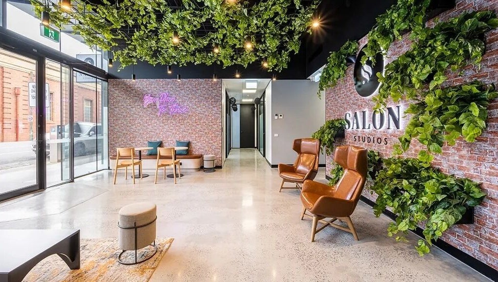 Spacious, modern interior of KC Hair / Kelvin of Canterbury in Melbourne, Victoria, AU with lush greenery and seating.