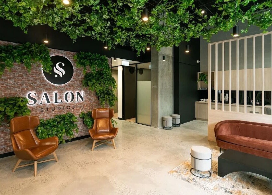 Inviting interior of KC Hair / Kelvin of Canterbury, Melbourne, Victoria, AU, with chic furniture and lush plants.