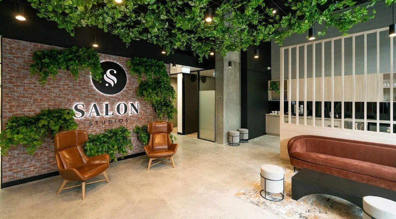 Inviting interior of KC Hair / Kelvin of Canterbury, Melbourne, Victoria, AU, with chic furniture and lush plants.