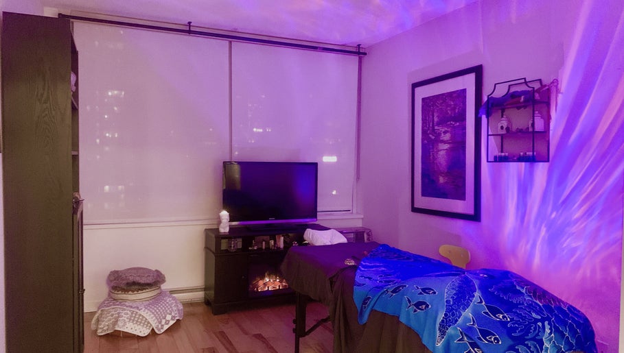 Tranquil massage room at Tension Release Studio, Vancouver, British Columbia, CA with calming purple lighting.