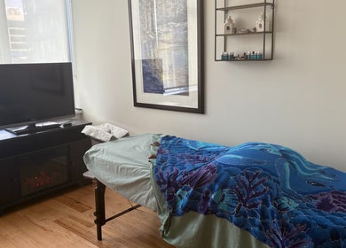 Relaxing massage room at Tension Release Studio, Vancouver, British Columbia, CA. Features cozy decor and calming ambiance.