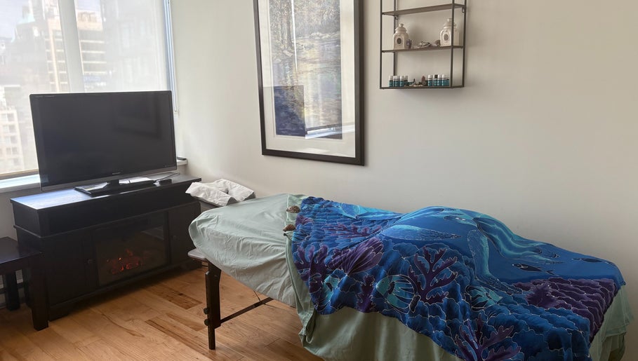 Massage room at Tension Release Studio, Vancouver, British Columbia, CA, featuring a tranquil setting with cozy decor.