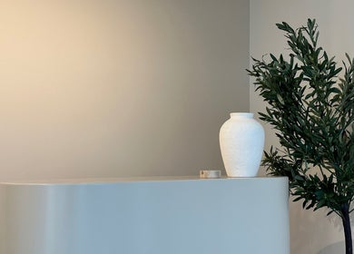 Minimalistic white vase and greenery at Volume 8, Auckland, Auckland, NZ, showcasing serene decor.