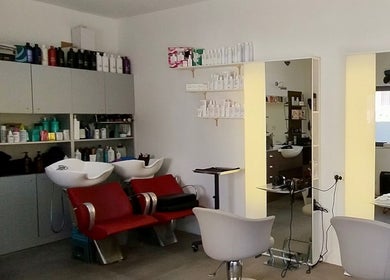 Inside Stranjé Hairdressing, Ħ'attard, MT showing modern salon chairs and sleek styling stations.