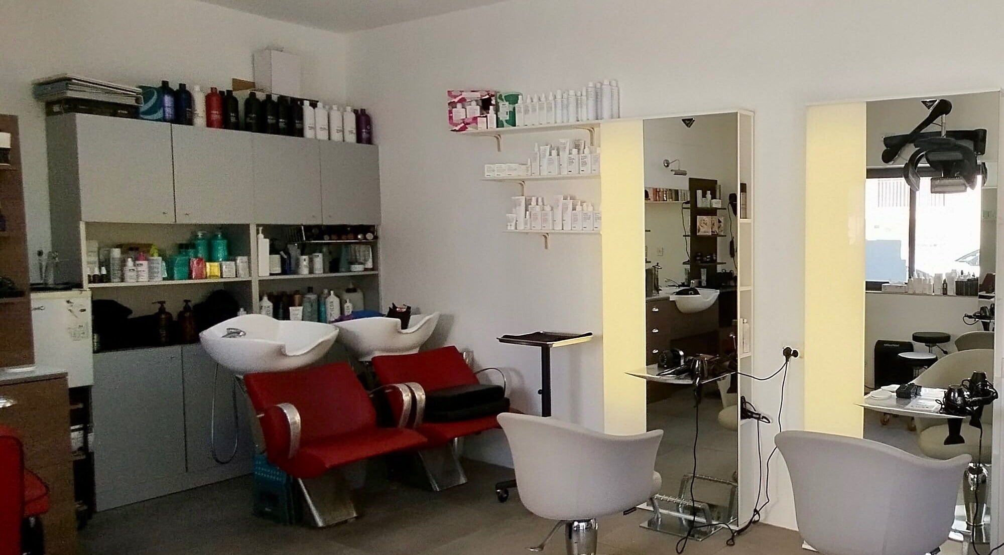 Inside Stranjé Hairdressing, Ħ'attard, MT showing modern salon chairs and sleek styling stations.