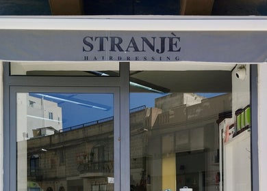 Entrance of Stranjé Hairdressing in Ħ'attard, MT, featuring a stylish canopy and modern design.
