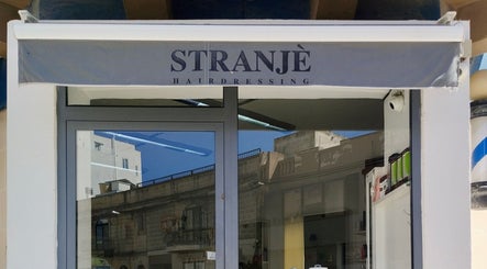 Entrance of Stranjé Hairdressing in Ħ'attard, MT, featuring a stylish canopy and modern design.