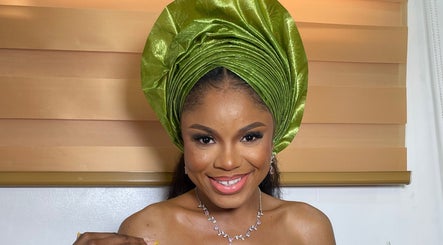 Smiling woman in elegant green headwrap at Pwencex Empire, Kingswinford, England, GB.