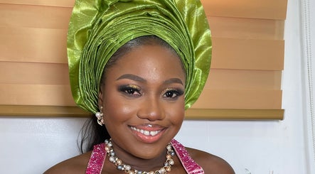 Smiling woman in green headwrap at Pwencex Empire, Kingswinford, England, GB.