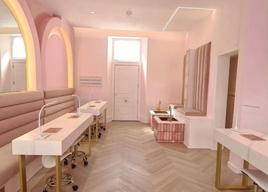 Chic beauty salon interior at By Élize in Plymouth, England, GB with pastel pink decor and manicure stations.