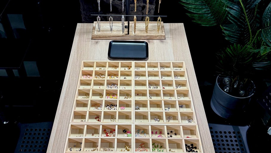 Diverse earring display at Tiger Bling, Edinburgh, Scotland, GB, showcasing various styles and colors.
