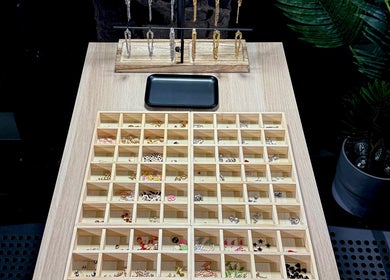Diverse earring display at Tiger Bling, Edinburgh, Scotland, GB, showcasing various styles and colors.
