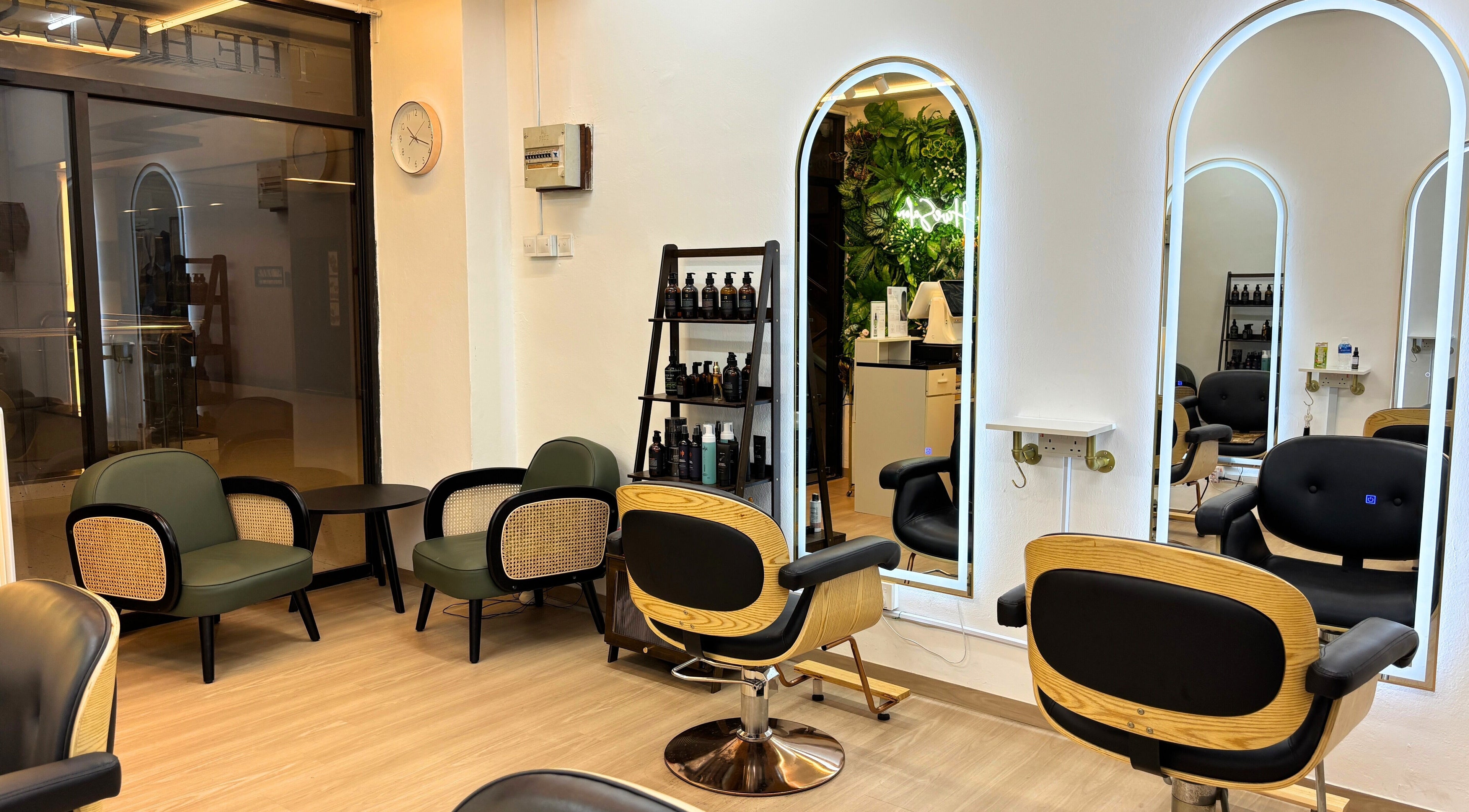 Modern interior of The Hive Salon, Singapore, SG, featuring stylish chairs and mirrors with sleek decor.