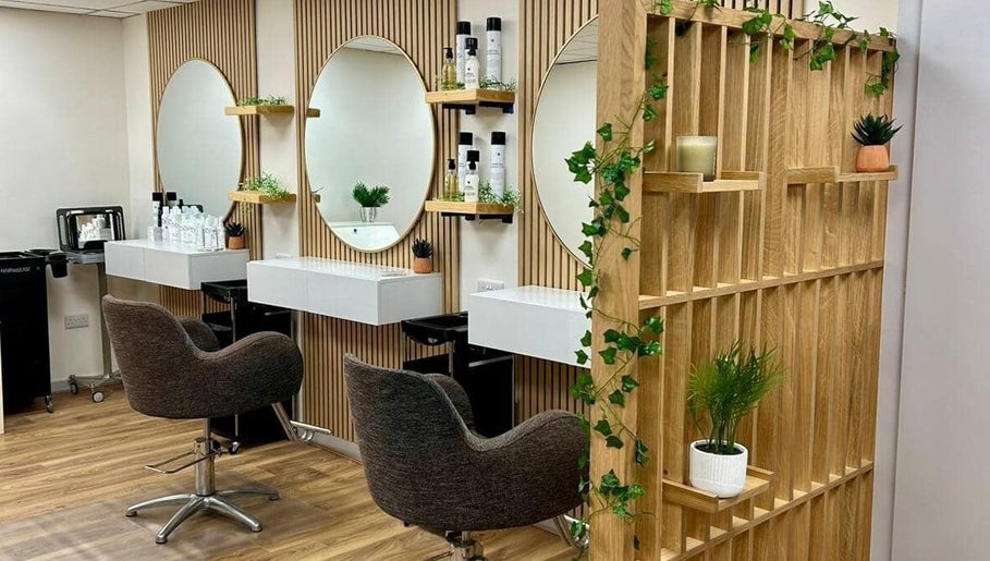 Elegant interior of Kindred Hair & Beauty, Brighton And Hove, with chic mirrors and stylish chairs.