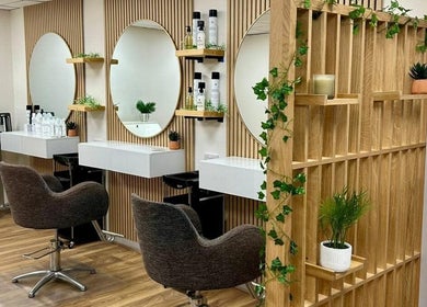 Elegant interior of Kindred Hair & Beauty, Brighton And Hove, with chic mirrors and stylish chairs.