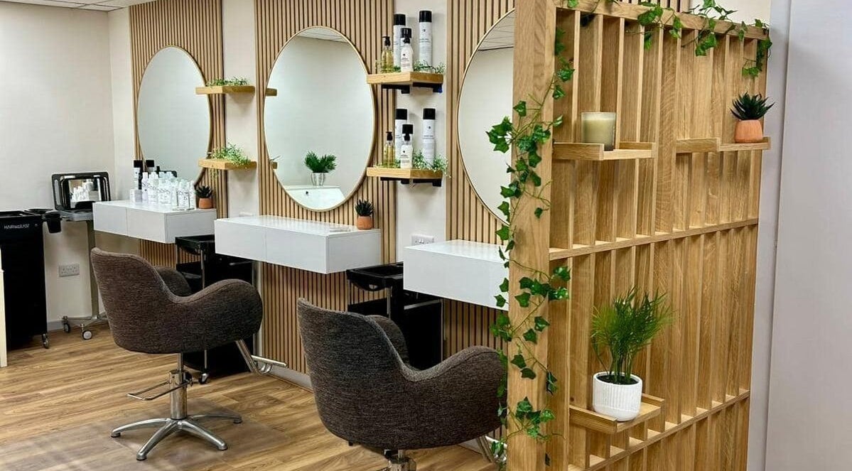 Elegant interior of Kindred Hair & Beauty, Brighton And Hove, with chic mirrors and stylish chairs.
