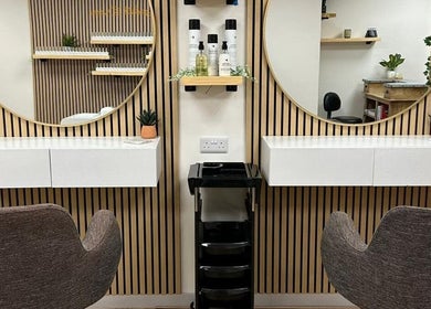 Modern salon setup at Kindred Hair & Beauty in Brighton And Hove, England, GB, featuring chic mirrors and chairs.